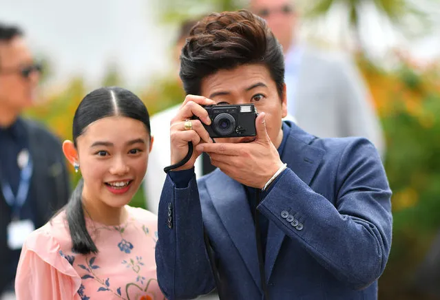 Japanese actor Takuya Kimura (R) takes a photo as Japanese actress Hanna Sugisaki looks on, during photocall on May 18, 2017 for the film “Blade of the Immortal” (Mugen no Junin) at the 70 th edition of the Cannes Film Festival in Cannes, southern France. (Photo by Loic Venance/AFP Photo)
