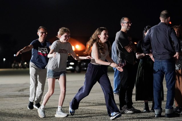 Russian-American journalist Alsu Kurmasheva's daughters Bibi and Miriam Butorin, and husband Pavel Butorin, run to meet her, upon her arrival at Joint Base Andrews, after her release from detention in Russia, in Maryland, U.S., August 1, 2024. (Photo by Nathan Howard/Reuters)