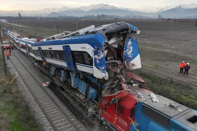 Aerial view of the two trains that collided in the commune of San Bernardo, in Santiago early in the morning on June 20, 2024. Two people were killed and several injured following the head-on collision between a goods train and a test train early in the morning on the outskirts of Chile's capital, the railway company reported. (Photo by Javier Torres/AFP Photo)