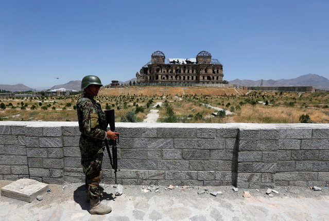 An Afghan National Army (ANA) soldier stands guard after the inauguration of the reconstruction project to restore the ruins of historic Darul Aman palace, in Kabul, Afghanistan May 30, 2016. (Photo by Omar Sobhani/Reuters)