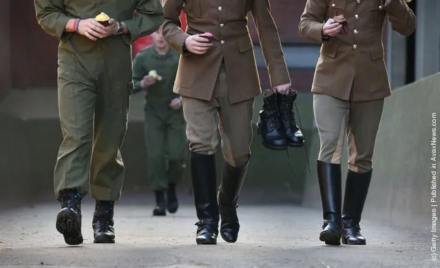 Members of  The Household Cavalry Mounted Regiment (HCMR) carry cupcakes for breakfast and a pair of boots before parade at Hyde Park Barracks