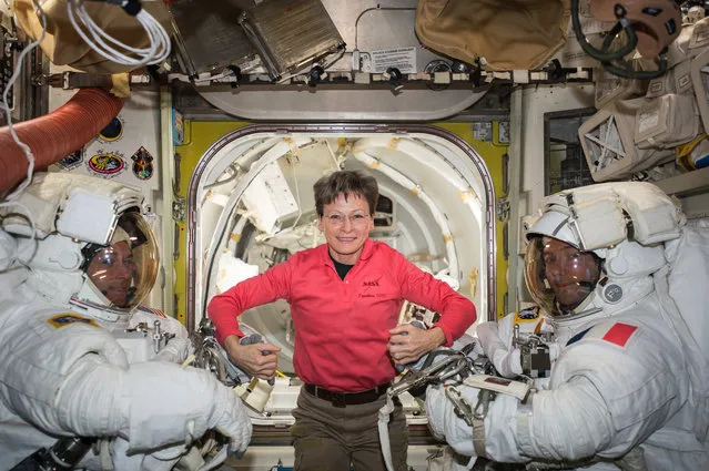 A handout photo made available by NASA's Johnson Space Center shows NASA astronaut Peggy Whitson (C) posing with Expedition 50 Commander Shane Kimbrough of NASA (L) and Flight Engineer Thomas Pesquet of ESA (European Space Agency, R) prior to their spacewalk, in space, 24 March 2017 (issued 24 April 2017). The pair conducted a six hour and 34 minute spacewalk on 24 March 2017. According to NASA, Whitson will officially set on 24 April 2017, the US record for most cumulative days in space aboard the International Space Station (ISS), surpassing the 534 days record of astronaut Jeff Williams. US President Donald Trump, his daughter Ivanka Trump, and NASA astronaut Kate Rubins will make a special Earth-to-space call on 24 April 2017, to congratulate Whitson for her record-breaking. (Photo by EPA/NASA)