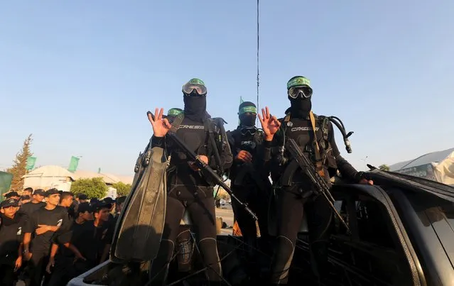 Palestinian members of the marine unit of al-Qassam Brigades, the armed wing of the Hamas movement, ride in a pick up truck during a military-style exercise at Liberation Youths summer camp, organised by the Hamas movement, in Rafah in the southern Gaza Strip, August 1, 2015. (Photo by Ibraheem Abu Mustafa/Reuters)