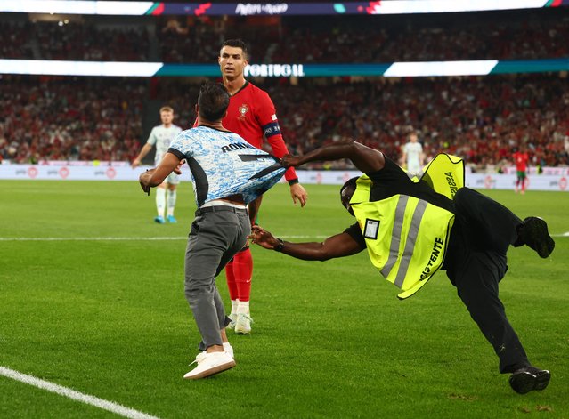 A pitch invader tries to get through to Cristiano Ronaldo of Portugal during the UEFA Nations League 2024/25 League A Group A1 match between Portugal and Scotland at Estadio do SL Benfica on September 8, 2024 in Lisbon, Portugal. (Photo by Pedro Nunes/Reuters)