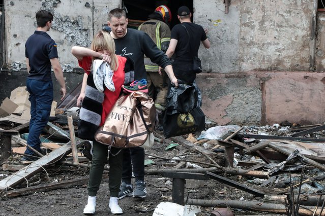 A woman, holding her belongings, cries in front of damaged house after missile hits residential building in Kryvyi Rhi, Donbas Oblast, Ukraine as Russia-Ukraine war continues on June 13, 2023. At least 10 people were killed and 28 injured on Tuesday due to a missile strike in the city of Kryvyi Rih in southeastern Ukraineâs Dnipropetrovsk region. (Photo by Stas Yurchenko/Anadolu Agency via Getty Images)