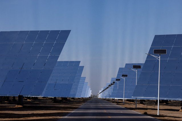 Fields of heliostat mirrors reflect sunlight at the site of Dunhuang Shouhang 100MW Tower Solar Thermal Power Generation Project, during an organised media tour to Dunhuang Photovoltaic Industrial Park, in Gansu province, China on October 16, 2024. (Photo by Tingshu Wang/Reuters)