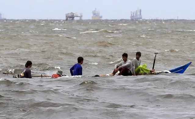 Fishermen on a small boat sail along the rough waves due to strong winds brought by Typhoon Goni, locally named as Ineng, at a Manila bay in Navotas city, north of Manila August 20, 2015. (Photo by Romeo Ranoco/Reuters)
