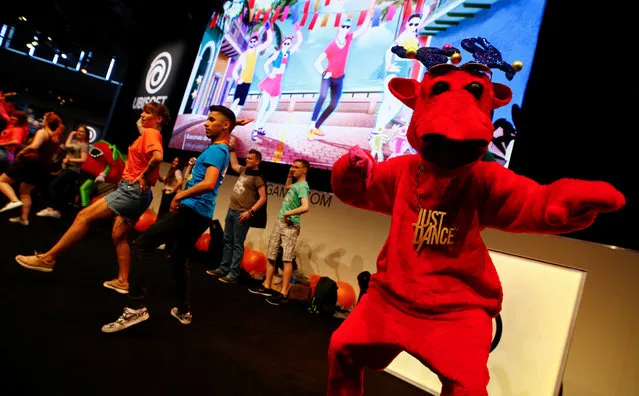 Visitors dance on stage with the Just Dance video game mascot at the world's largest computer games fair, Gamescom, in Cologne, Germany August 23, 2017. (Photo by Wolfgang Rattay/Reuters)