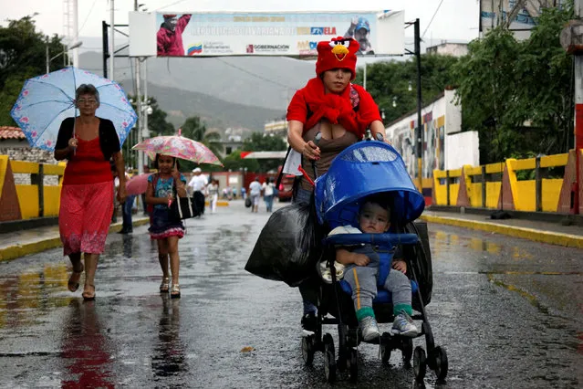 A woman push a pram with a baby and bags as she crosses the Colombian-Venezuelan border over the Simon Bolivar international bridge after shopping, in San Antonio del Tachira, Venezuela, July 16, 2016. (Photo by Carlos Eduardo Ramirez/Reuters)