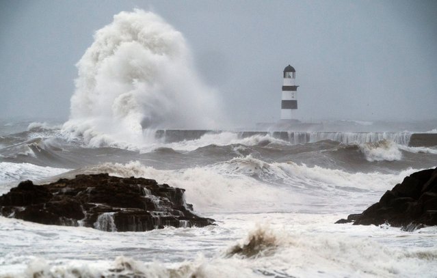 Waves crash against the lighthouse in Seaham Harbour, County Durham, UK on Thursday, September 26, 2024. Flooding and travel disruption is set to continue across large swathes of the UK with more rain predicted to hit. Nearly three inches of rain could fall over several hours in the worst-affected regions on Thursday. (Photo by Owen Humphreys/PA Images via Getty Images)