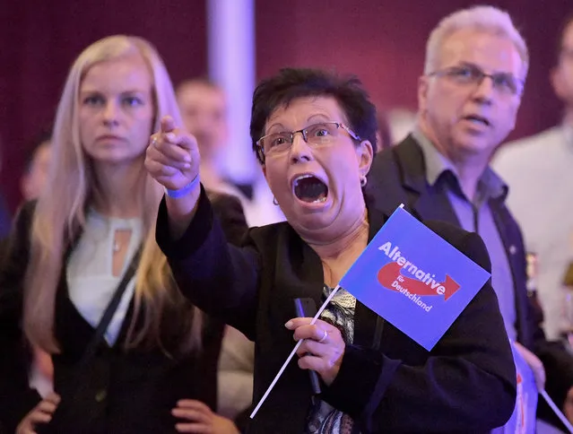 Guests at an Alternative for Germany party, AfD,  election party react to the first projections for the German election in Erfurt, Germany,  Sunday, September 24, 2017. (Photo by Martin Schutt/DPA via AP Photo)