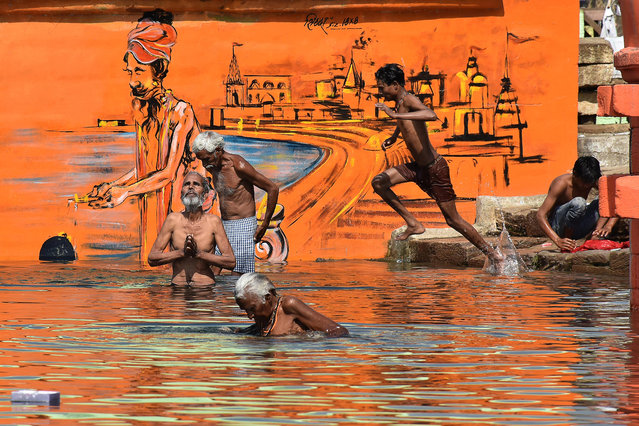 Hindu devotees bathe on the occasion of Akshaya Tritiya, a annual spring festival which is believed to bring good luck and success, during a government-imposed nationwide lockdown as a preventive measure against the spread of the COVID-19 coronavirus, at Narmada river in Jabalpur on April 26, 2020. (Photo by Uma Shankar Mishra/AFP Photo)