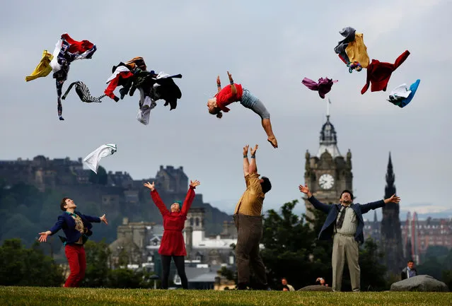 The cast from Hogwallops from the Lost in Translation Circus propel cast member Roisin Morris into the air on Calton Hill ahead of the Edinburgh festival fringe in Edinburgh, UK on August 2, 2016. (Photo by Murdo Macleod/The Guardian)