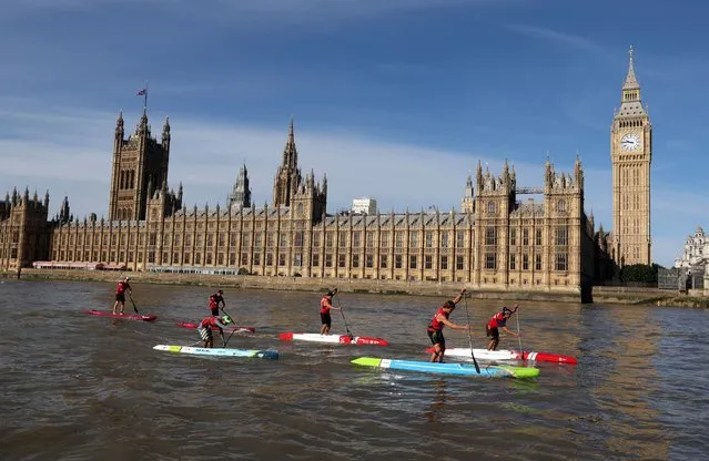 General view as the athletes in men's pro distance race on the Thames during the SUP World Tour pass the Houses of Parliament in London, Britian on September 18, 2022. (Photo by Paul Childs/Action Images via Reuters)