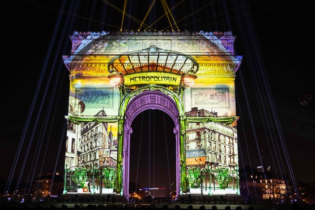 This photograph taken on December 31, 2023, shows the Arc de Triomphe illuminated for the New Year celebrations in Paris. (Photo by Bertrand Guay/AFP Photo)