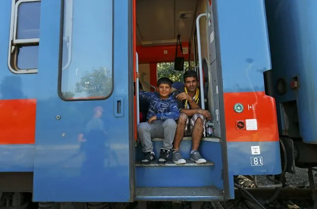 Migrants sit in a train heading towards the Austrian border from Roszke, Hungary September 14, 2015. (Photo by Laszlo Balogh/Reuters)