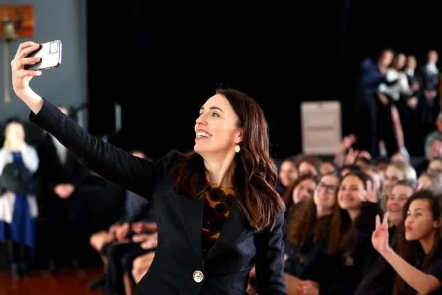 New Zealand Prime Minister Jacinda Ardern takes a selfie with students at Northcote College on July 03, 2020 in Auckland, New Zealand. Prime Minister Jacinda Ardern and Education Minister Chris Hipkins have announced a new nationwide school redevelopment programme to upgrade schools over the next 10 years. The first phase of the National School Redevelopment Programme will see up to $1.3 billion invested to improve up to 40 schools across New Zealand. (Photo by Hannah Peters/Getty Images)