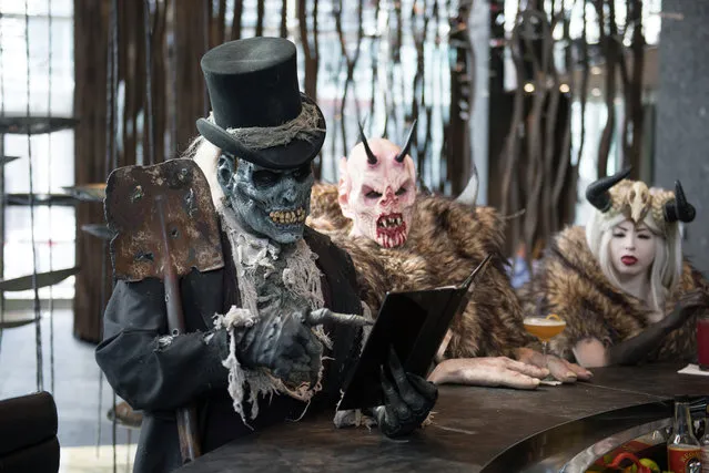 Monsters from Netherworld Haunted House (from left)  The Collector, Crampus and the Crampus Queen at Living Room at W Atlanta Downtown hotel on Thursday, October 7, 2014. (Photo by Hyosub Shin/AJC)