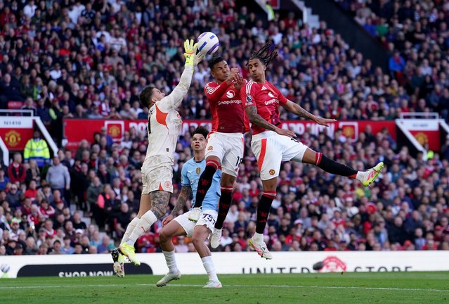 Manchester United's Casemiro (centre) and Leny Yoro (right)challenge Manchester City goalkeeper Ederson (left) for the ball during the Premier League match at Old Trafford, Manchester on Sunday, April 6, 2025. (Photo by Martin Rickett/PA Wire)