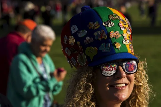 An attendee smiles as she watches hundreds of hot air balloons lift off on the first day of the 2015 Albuquerque International Balloon Fiesta in Albuquerque, New Mexico, October 3, 2015. (Photo by Lucas Jackson/Reuters)