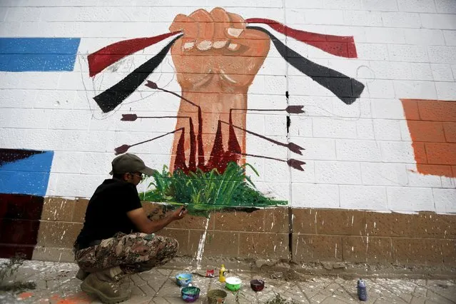 A pro-Houthi activist paints graffiti during a campaign against Saudi-led air strikes on the wall of the Saudi embassy in Sanaa August 2, 2015. (Photo by Khaled Abdullah/Reuters