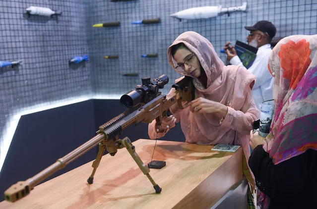 A visitor checks automatic gun during International Defence Exhibition and Seminar (IDEAS) 2022 at the Expo Centre in Karachi on November 16, 2022. (Photo by Rizwan Tabassum/AFP Photo)