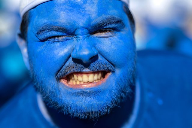 A participant wearing a smurf (schtroumpf) costume takes part in an attempt to break the world record for the largest gathering of Smurfs, in Landerneau, western France, on May 17, 2025. Landerneau on May 17 attempts to break the world record for the largest Smurfs gathering, a record held by Lauchringen in Germany, after two failed attempts over five years. (Photo by Fred Tanneau/AFP Photo)