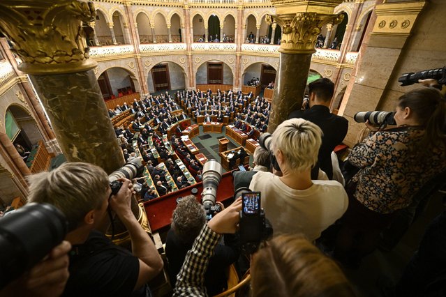 Photographers take pictures as Hungarian Prime Minister Viktor Orban, center right, stands after addressing a parliament session, on the day lawmakers are expected to approve Sweden's accession into NATO, in Budapest, Hungary, Monday, February 26, 2024. Hungary's parliament is to vote Monday on ratifying Sweden's bid to join NATO, likely bringing an end to more than 18 months of delays that have frustrated the alliance as it seeks to expand in response to Russia's war in Ukraine. (Photo by Denes Erdos/AP Photo)