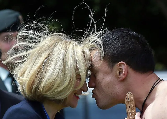 Laureen Harper (L), the wife of Canadian Prime Minister Stephen Harper, performs a “Hongi” with a traditionally dressed Maori warrior during a welcoming ceremony at Government House in Auckland November 14, 2014. (Photo by Shane Wenzlick/Reuters)