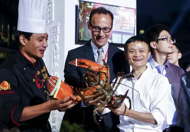 Alibaba Group‘s executive chairman Jack Ma (R, in white) holds a lobster at a display area for fresh food ingredient vendors, who recently signed a cooperation agreement with Alibaba's Tmall, after the launch event of Tmall 11.11 Global Shopping Festival, at the company's headquarters in Hangzhou, Zhejiang province, China, October 13, 2015. (Photo by Reuters/Stringer)