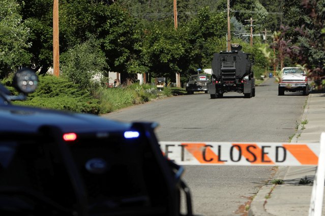 An armored police vehicle travels towards an area where multiple firefighters were attacked when responding to a fire in the Canfield Mountain area outside Coeur d’Alene, Idaho, U.S. June 29, 2025. (Photo by Young Kwak/Reuters)