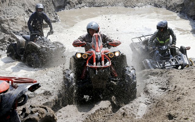 ATV drivers try to drive through a mud pit during the OFFROAD KINGS off-road club's Jeep Sprint Cup spring festival in the village of Ozernoye, about 35 kilometers from Bishkek, Kyrgyzstan, 14 April 2024. Amateurs of all-terrain vehicles (quad bikes) from Kyrgyzstan, Kazakhstan, Russia, and Uzbekistan took part in the races in various categories. (Photo by Igor Kovalenko/EPA/EFE)
