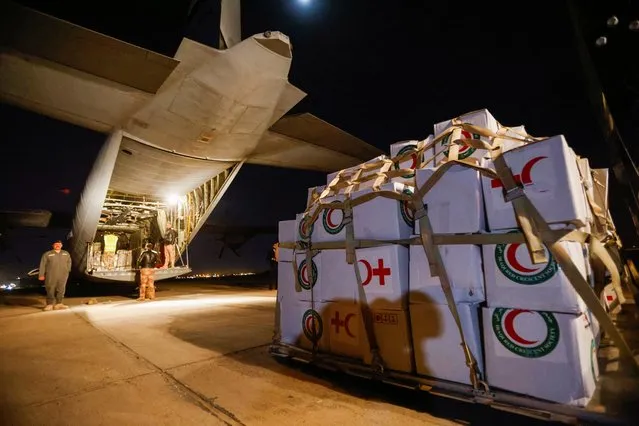 Workers and security forces process aid from Red Crescent that will be shipped on a plane of emergency relief to Syria to support victims of the deadly earthquake, at a military airbase near Baghdad International Airport in Baghdad, Iraq, February 6, 2023. (Photo by Ahmed Saad/Reuters)