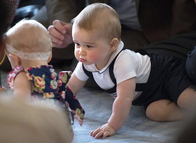 Britain's Prince George, right, plays during a visit to Plunket nurse and parents group at Government House in Wellington, New Zealand, April 9, 2014. (Photo by Marty Melville/Pool Photo via AP Photo)