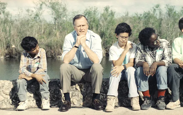 President George H. Bush could pass for just another school boy with the expression he wears as he and a group of school kids listen to Everglade Park Rangers talk about the Florida Everglades on Friday afternoon, January 19, 1990 in the National Park. The President was in Florida to attend a fund raising dinner for Gov. Bob Martinez. (Photo by Ron Edmonds/AP Photo)