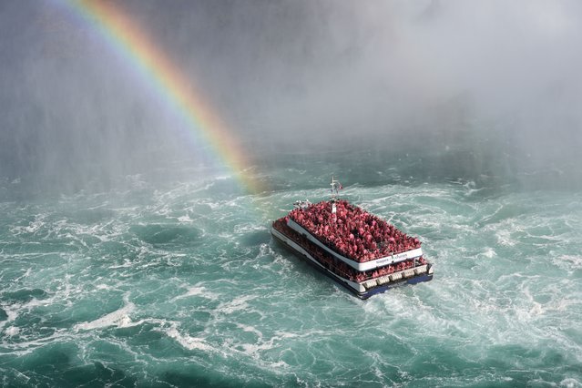 A rainbow appears as people enjoy a warm afternoon on a tour boat at Niagara Falls in Ontario, Canada on October 21, 2024. (Photo by Mert Alper Dervis/Anadolu via Getty Images)