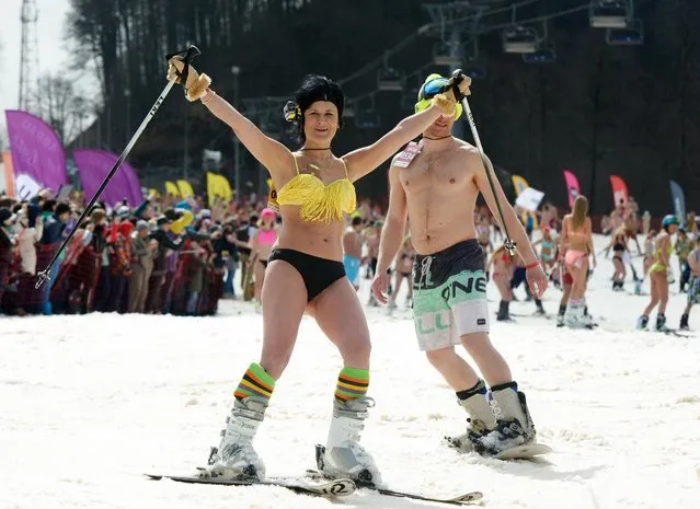 People in swimsuits participate in the BoogelWoogel alpine carnival at the Rosa Khutor Alpine Resort in Krasnaya Polyana, Sochi, Russia on March 31, 2018. (Photo by Artur Lebedev/TASS)