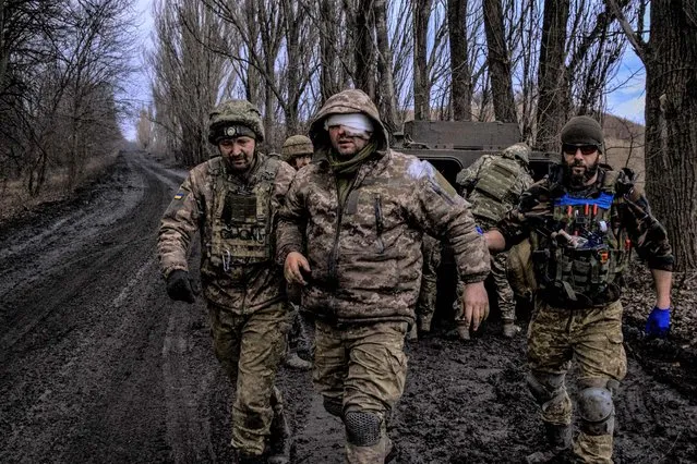 Ukrainian combat medics evacuate a wounded Ukrainian servicem?n from the front line near Bakhmut, on March 8, 2023, amid the Russian invasion of Ukraine. (Photo by Sergey Shestak/AFP Photo)
