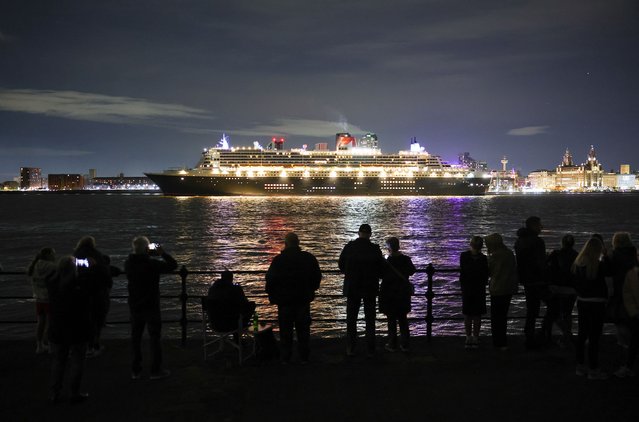 People watch from the banks of the River Mersey as the Cunard Line flagship Queen Mary II departs from Liverpool, Britain, 19 September 2025. The Queen Mary II visited Liverpool as part of celebrations for the 185th anniversary of the Cunard Line, which was headquartered in Liverpool from 1840 until 1967 and still regards the city as its “spiritual home”. (Photo by Adam Vaughan/EPA)