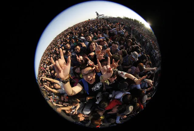 Concert-goers dance and gesture during a performance at the 2013 Strawberry Music Festival at Tongzhou Canal Park in Beijing, April 29, 2013. (Photo by Barry Huang/Reuters)