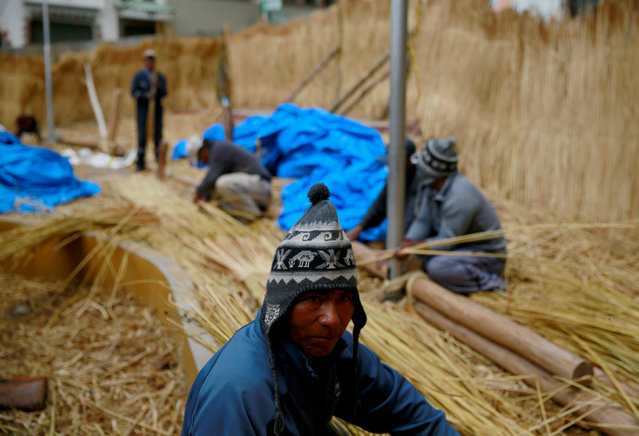 Aymara builders work on the “Viracocha III”, a boat made only from the totora reed, as it is being prepared to cross the Pacific from Chile to Australia on an expected six-month journey, in La Paz, Bolivia, October 19, 2016. (Photo by David Mercado/Reuters)