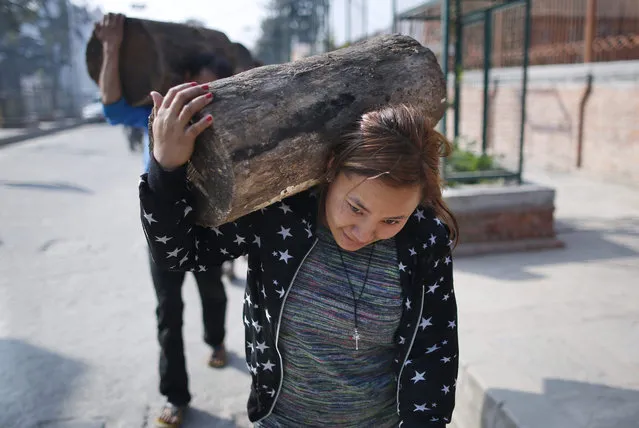 Nepalese households carry firewood on their backs in Kathmandu, Nepal, 15 November 2015. The Nepal government was to sell firewood to the public from 15 November to ease the fuel crisis situation, authorities said. Nepal is facing fuel shortages due to a border blockade by India, which cites anti-constitution protests in the southern Terai region over the past three months. (Photo by Narendra Shrestha/EPA)