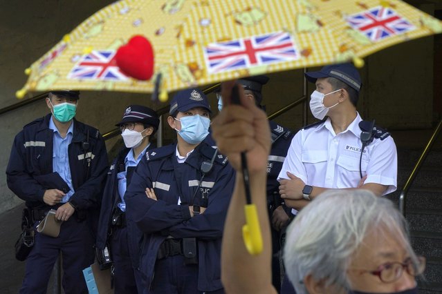 Pro-democracy activist Alexandra Wong holding yellow umbrella with British flags protests outside the Chinese central government's liaison office, in Hong Kong, Monday, December 28, 2020, to demand the release of the 12 Hong Kong activists detained at sea by Chinese authorities. (Photo by Kin Cheung/AP Photo)