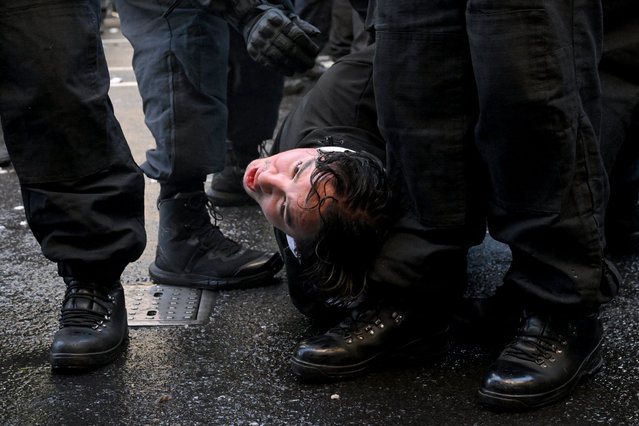 Police officers hold down a supporter of Tommy Robinson, during a demonstration, in London, on September 13, 2025. (Photo by Jaimi Joy/Reuters)