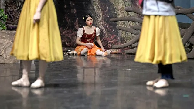 Bogdana Alekseeva, a ballet dancer displaced by the war in Ukraine, pauses before the staging of the ballet Giselle to the music of Adolphe Charles Adam, at the Romanian National Opera, in Bucharest, Romania, Sunday, March 20, 2022. Ukrainian ballet dancers who fled from the war in their country performed alongside their Romanian counterparts after being offered the chance to perform in the ballet Giselle, by the Romanian National Opera. (Photo by Andreea Alexandru/AP Photo)