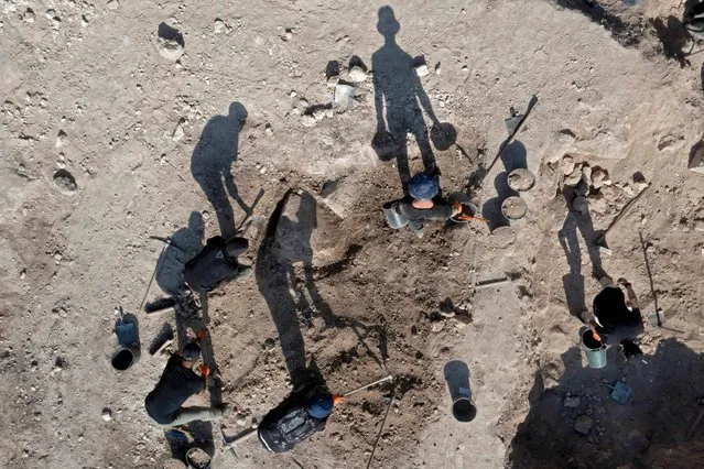 An aerial photo taken by drone shows archaeologists working at the Tomb of Salome work at the Salome Cave in the Lachish national park west of Jerusalem, on December 20 2022. Israel today unveiled pilgrims' lamps and other finds from the so-called Tomb of Salome, an early Christian burial site named for a woman said to have assisted at the birth of Christ. (Photo by Menahem Kahana/AFP Photo)