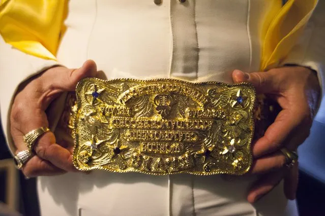 A participant shows off a belt buckle during the 20th annual Seattle Invitationals, an amateur Elvis impersonator competition, in Seattle, Washington January 23, 2015. The event drew hundreds of spectators for 20 contestants at the Crocodile, a venue in Seattle's Belltown neighborhood. (Photo by David Ryder/Reuters)