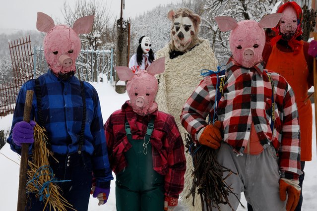 Masked revelers wait for the start of the carnival parade in the village of Vevcani, North Macedonia in the eve of Orthodox St. Basil's day, marking the beginning of the New Year by the Julian calendar, on Monday, January 13, 2025. (Photo by Boris Grdanoski/AP Photo)