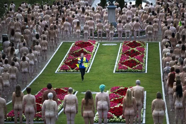 Volunteers prepare to pose nude for US art photographer Spencer Tunick in Kuopio, Finland, on a summer night on July 15, 2023. (Photo by Matias Honkamaa/Rex Features/Shutterstock)