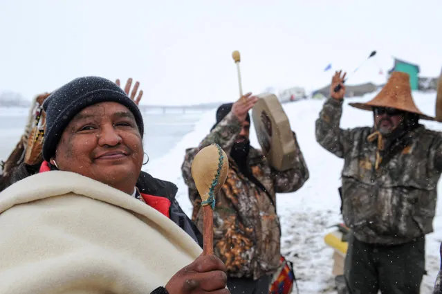 Men play traditional musical instruments in the Oceti Sakowin camp during a protest against plans to pass the Dakota Access pipeline near the Standing Rock Indian Reservation, near Cannon Ball, North Dakota, U.S. December 1, 2016. (Photo by Stephanie Keith/Reuters)
